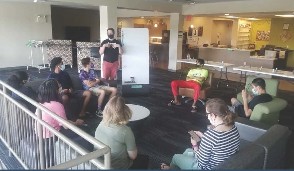 residence hall students in lounge listening