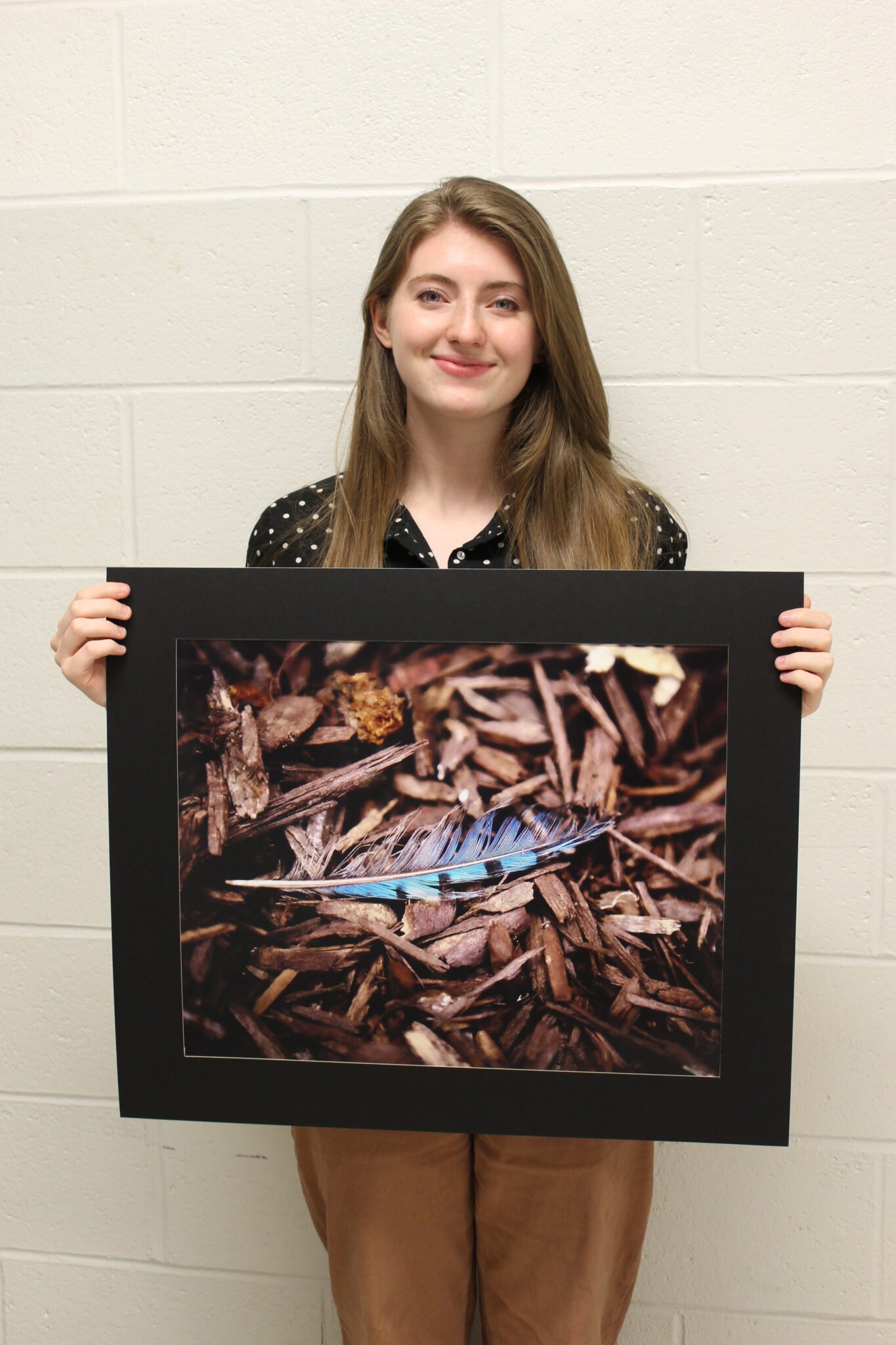 Photo of student holding artwork