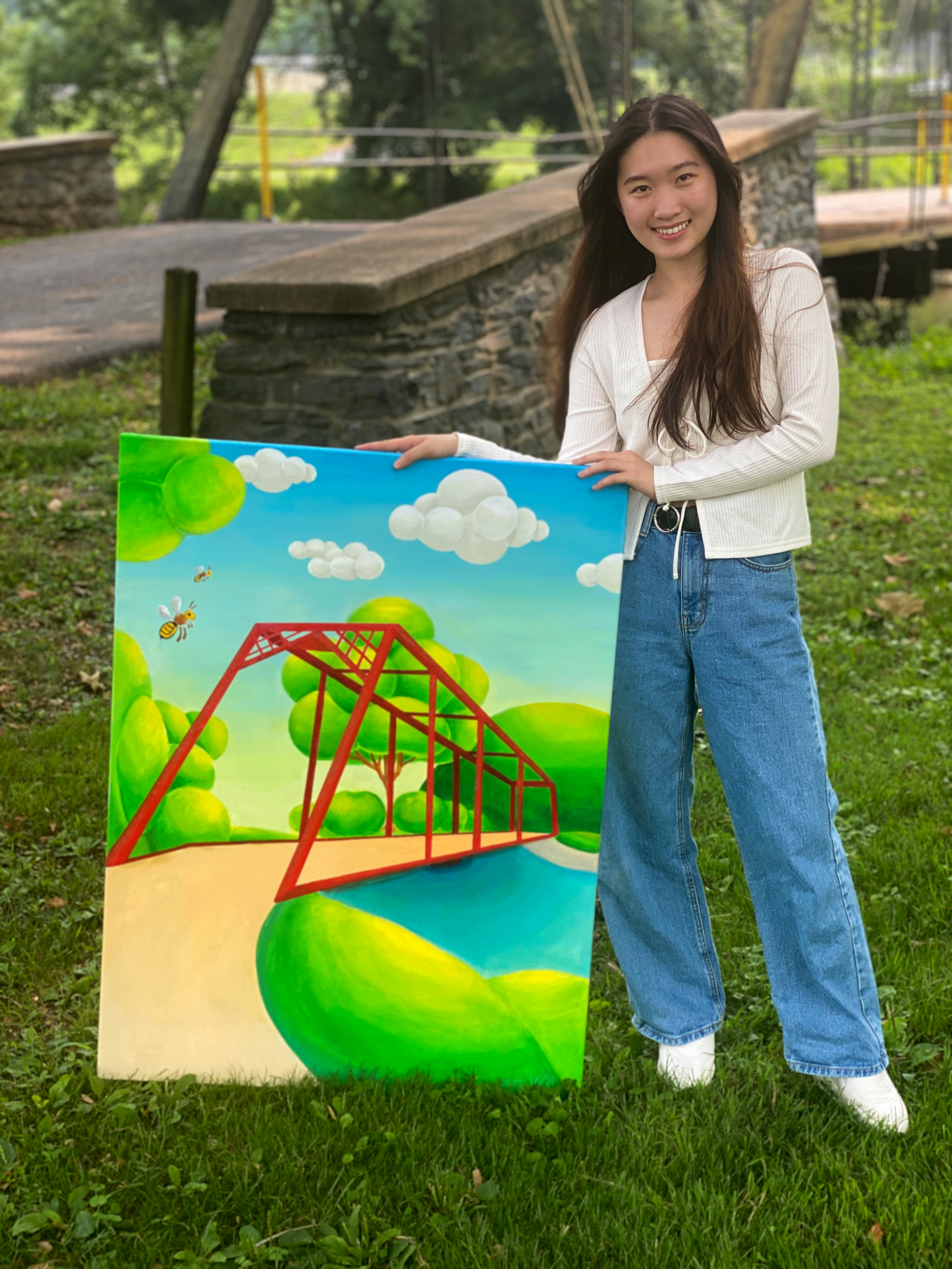 student near bridge with her bright colored bridge painting