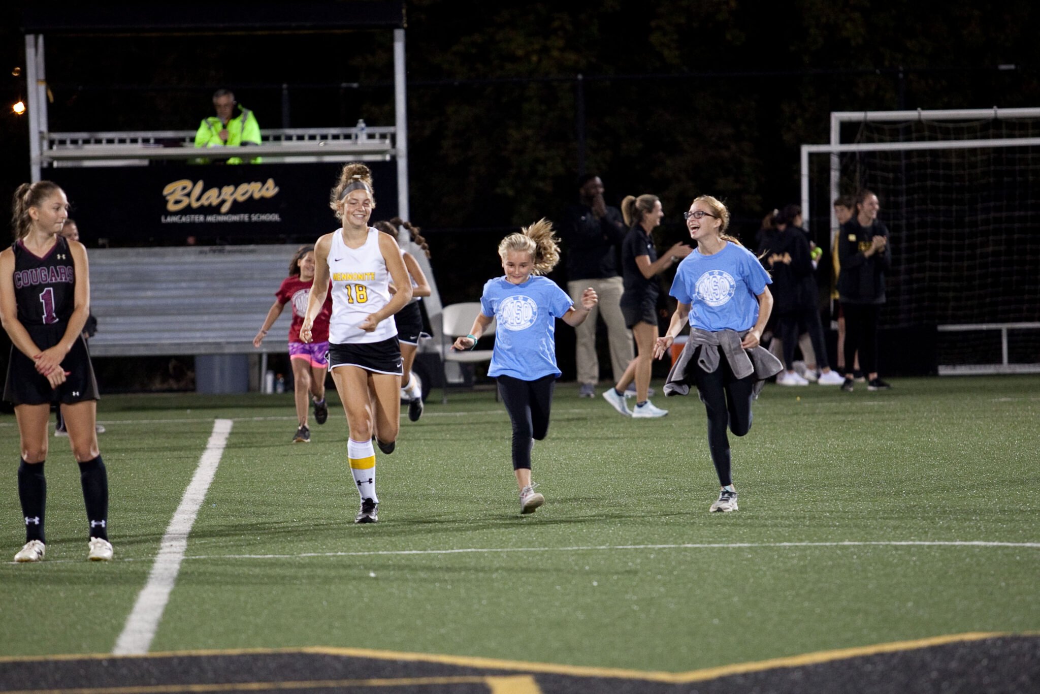 Player and young girls running