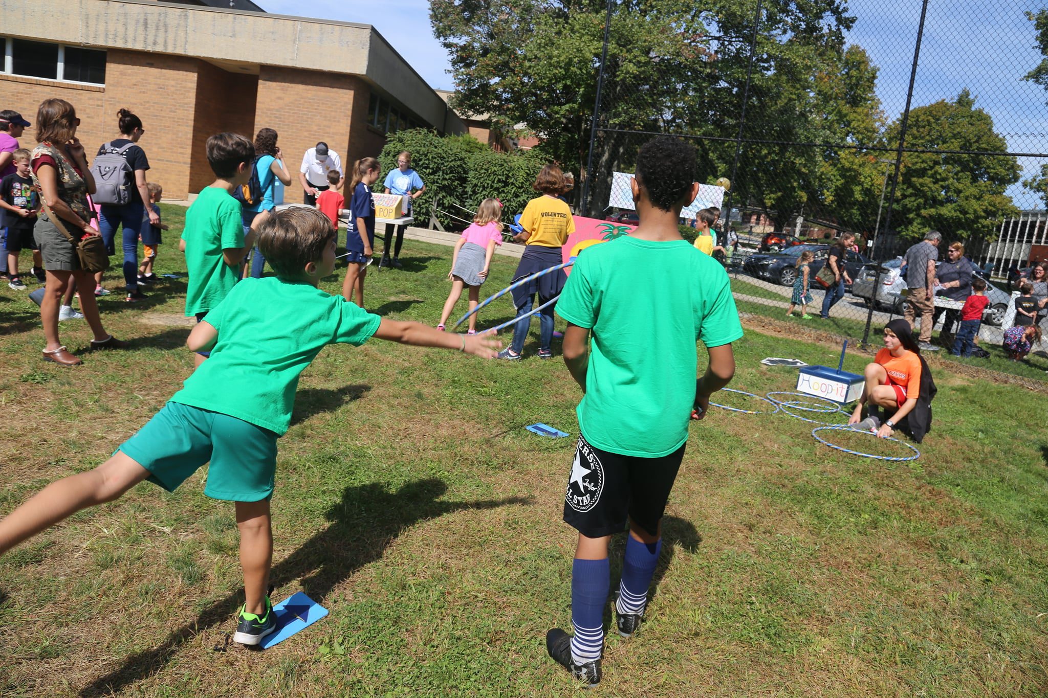 Kids throwing hula hoops