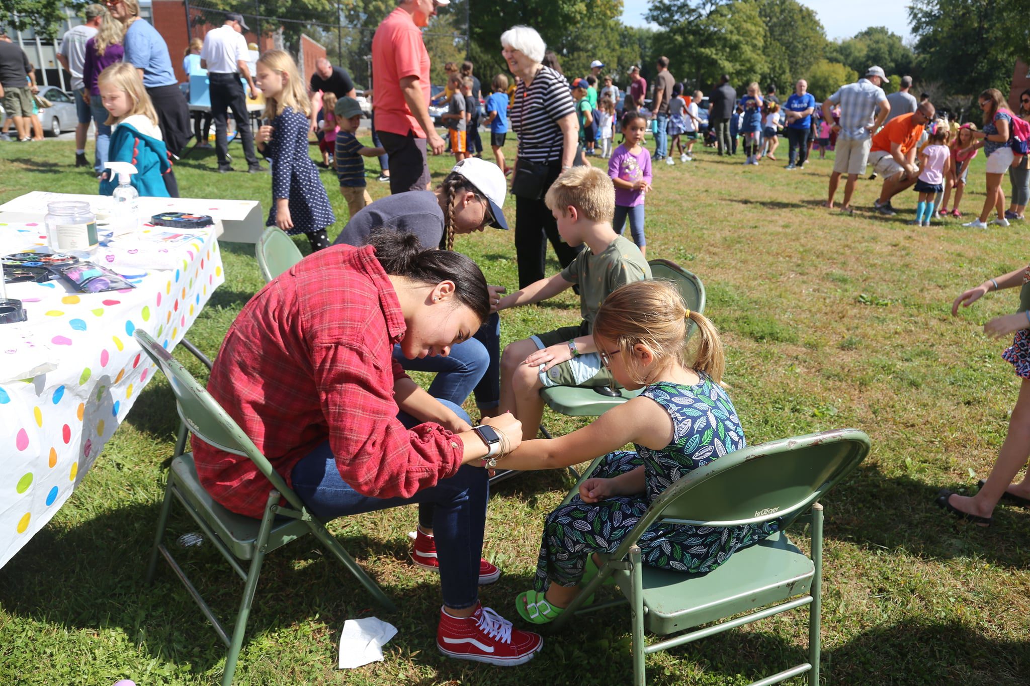 Kids getting their arms painted