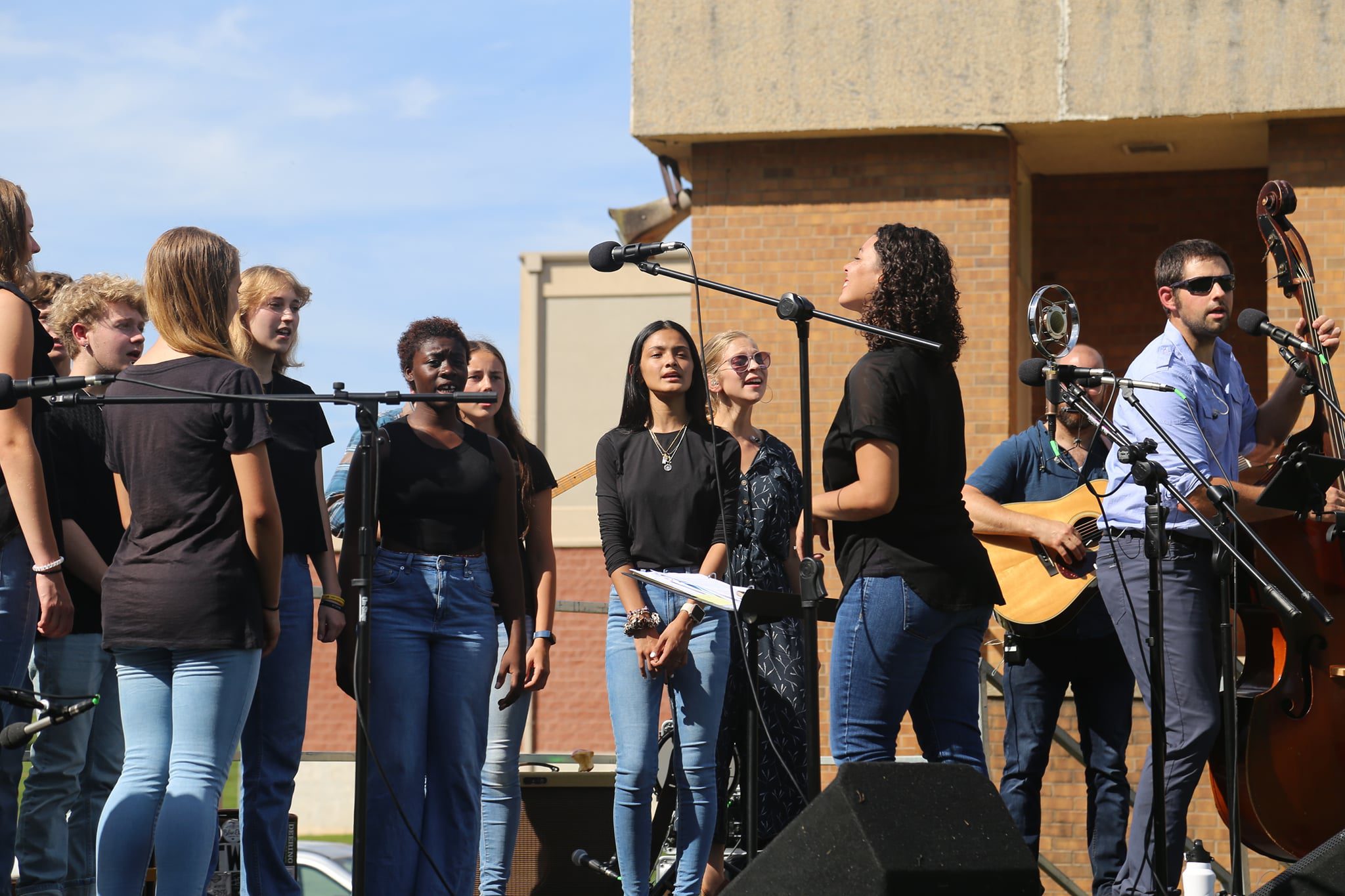 students on stage singing