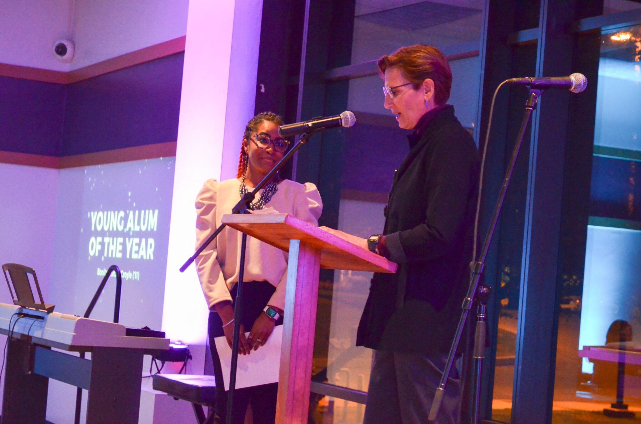 two women reading at podium