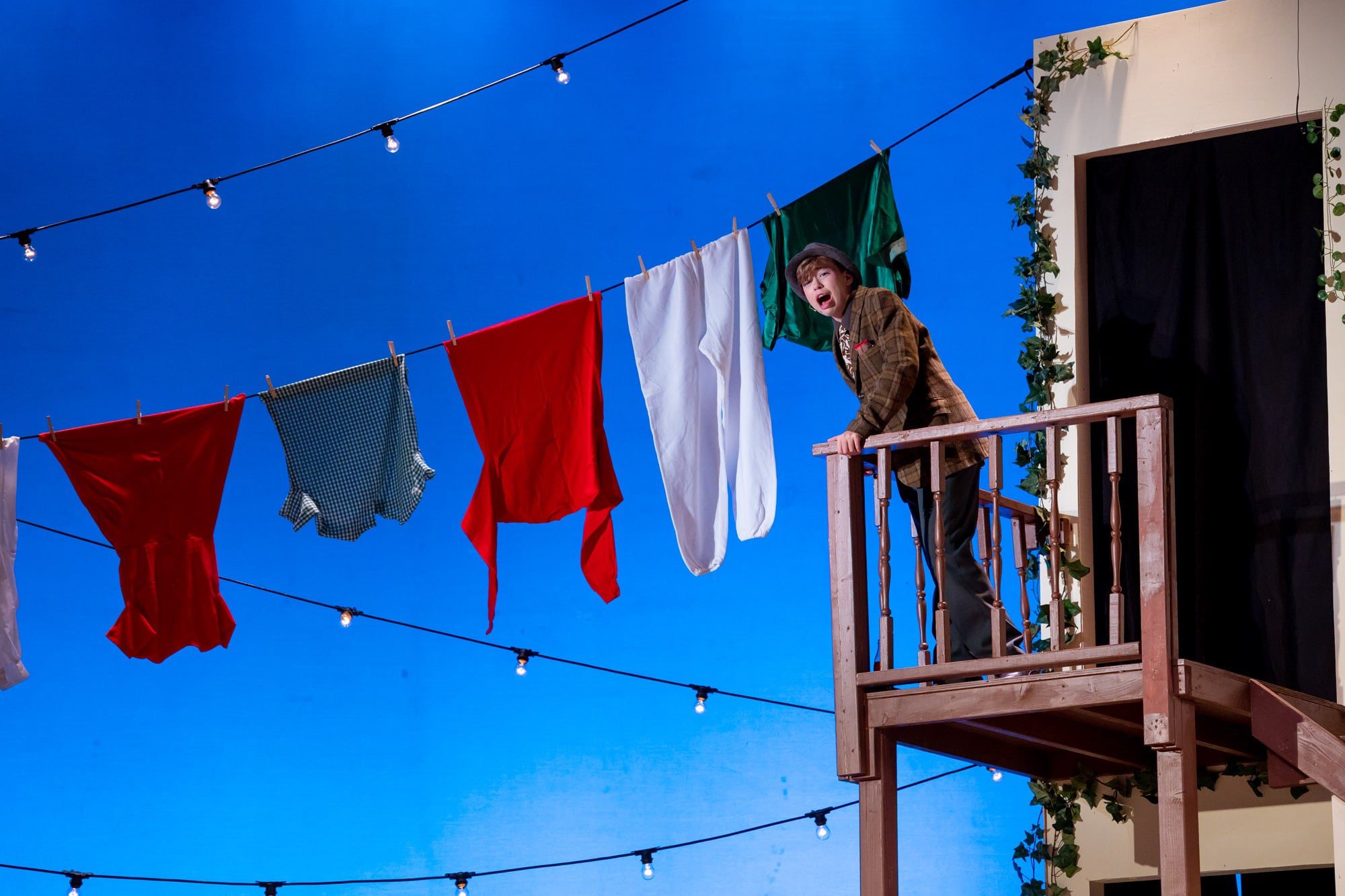 student overlooking laundry line on stage