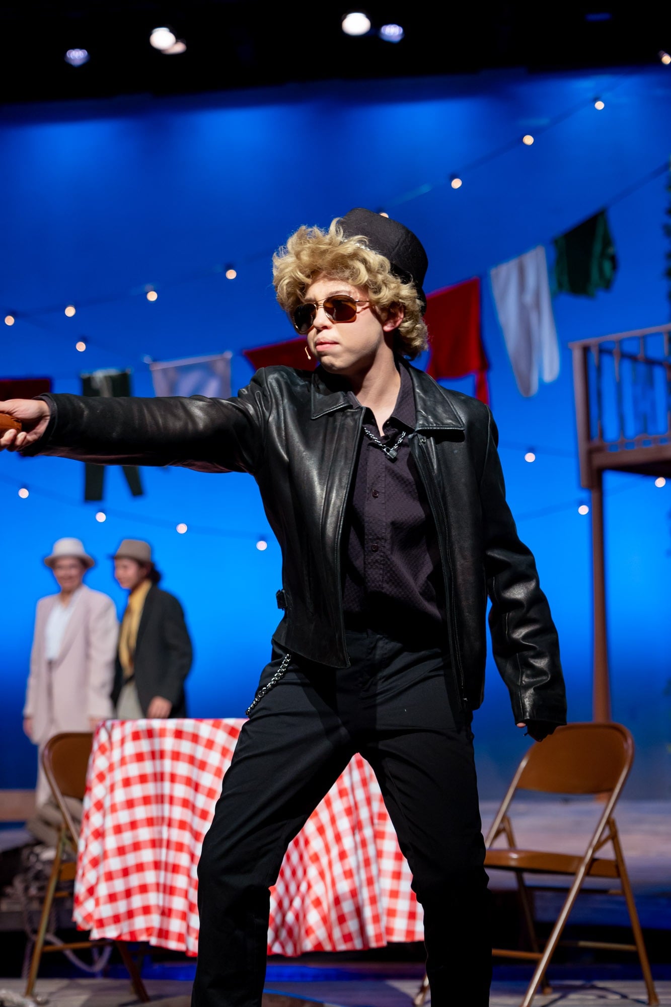 student in leather jacket in fall play