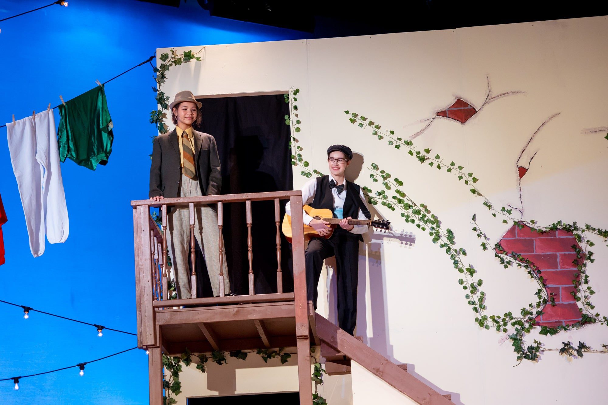 two students standing on stairs at play