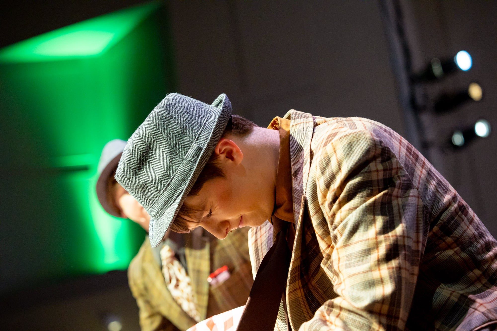 student wearing fedora in play