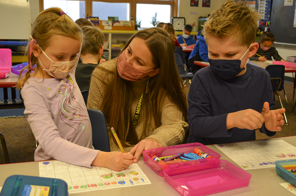 teacher helping students