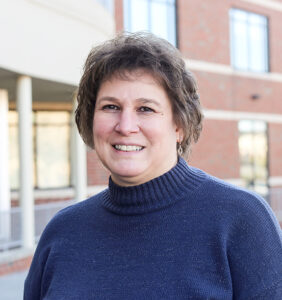 Lorri Hengst headshot outside of school building