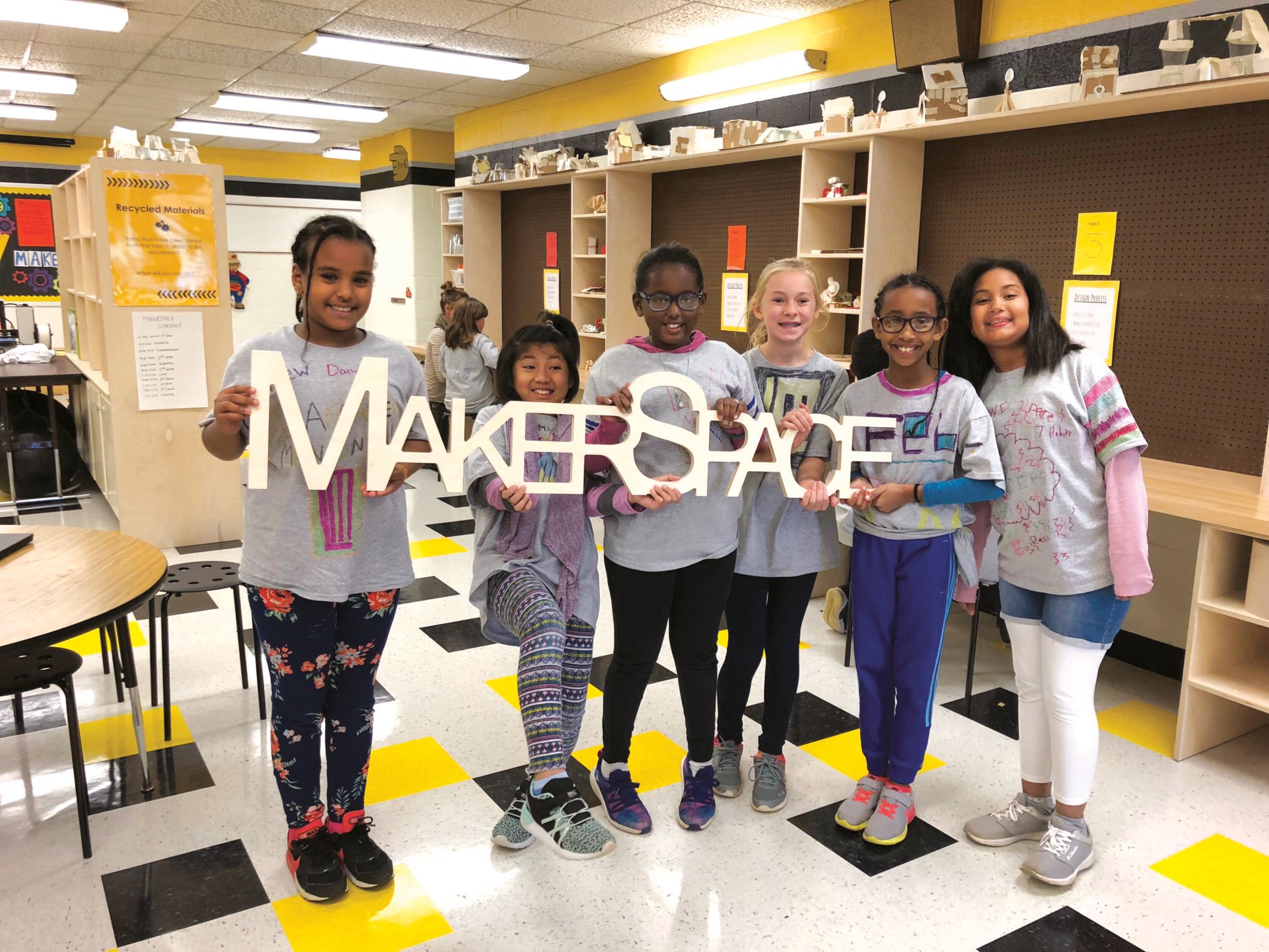 students holding makerspace letters