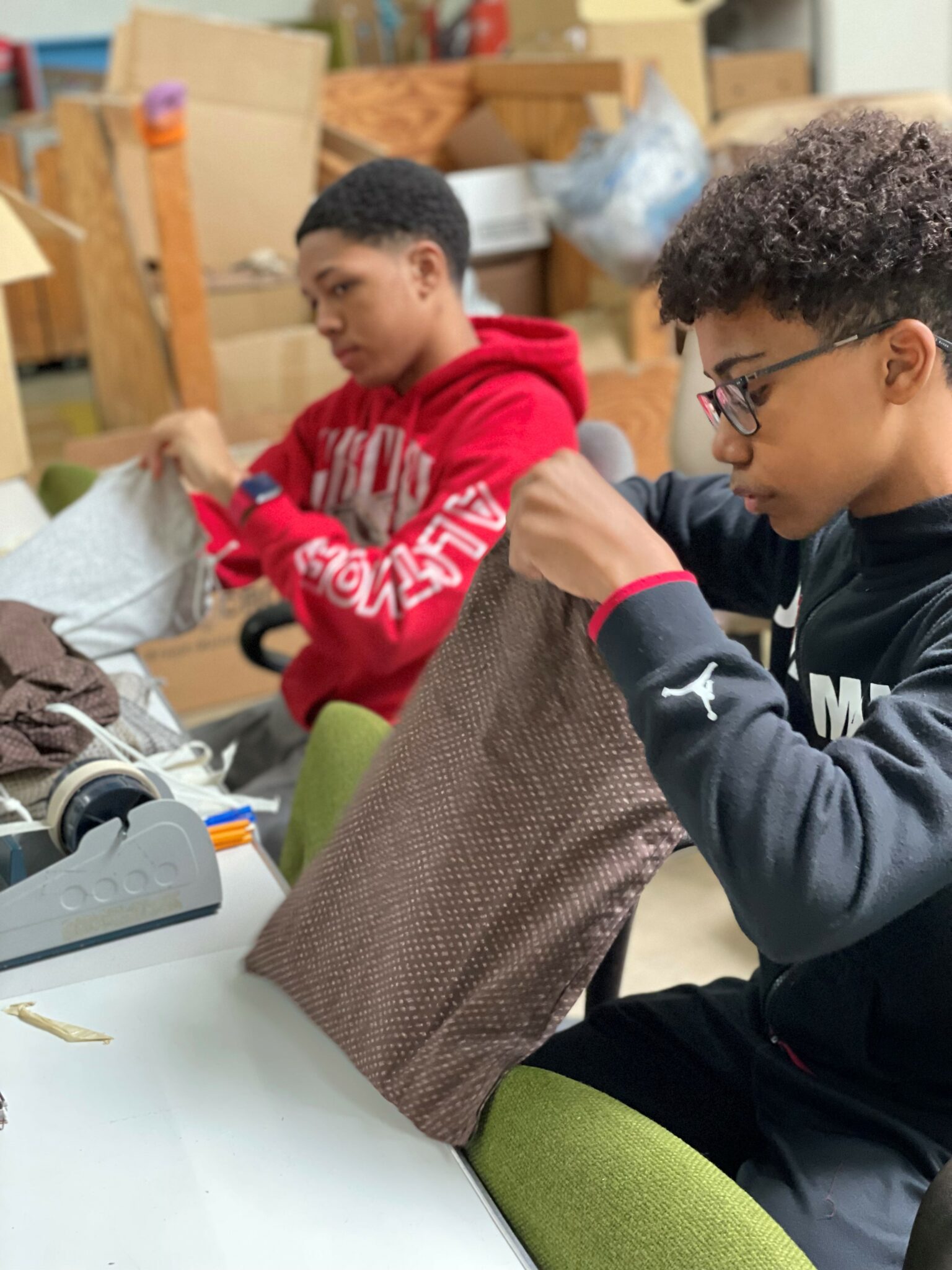 two boys sewing