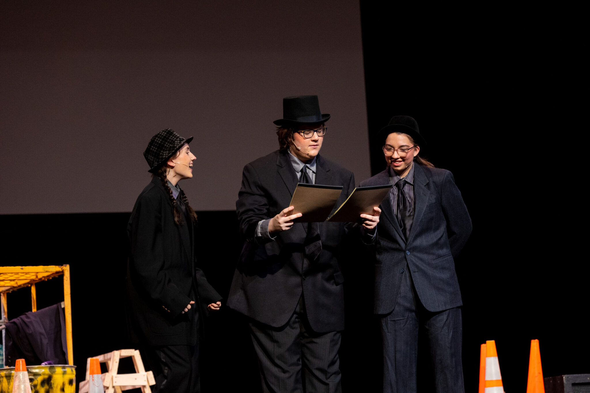 three students on stage