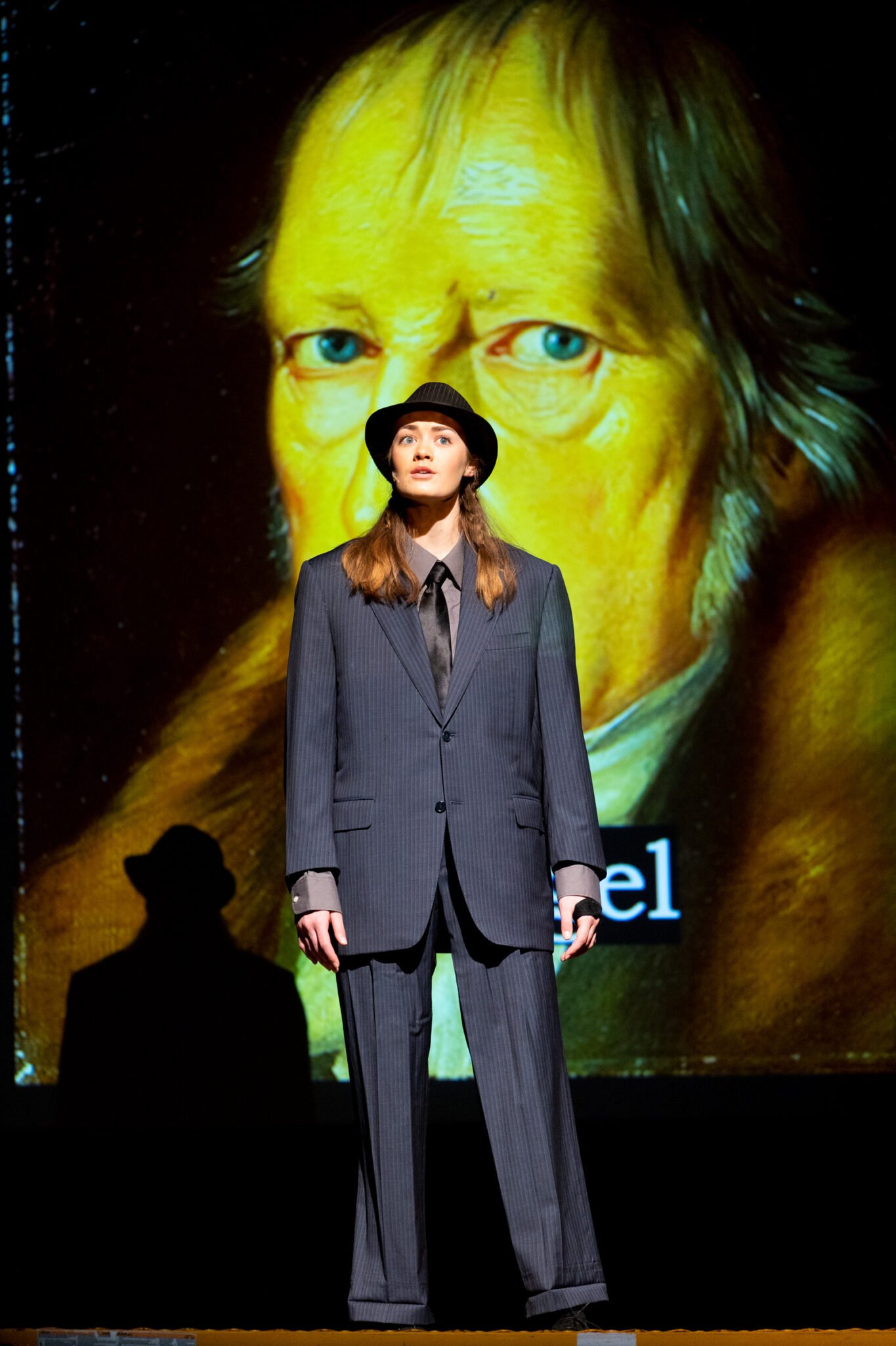 girl on stage wearing a suit