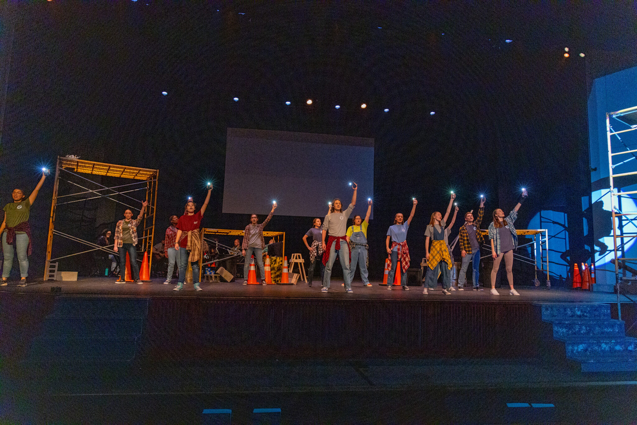 2022 godspell cast holding lights