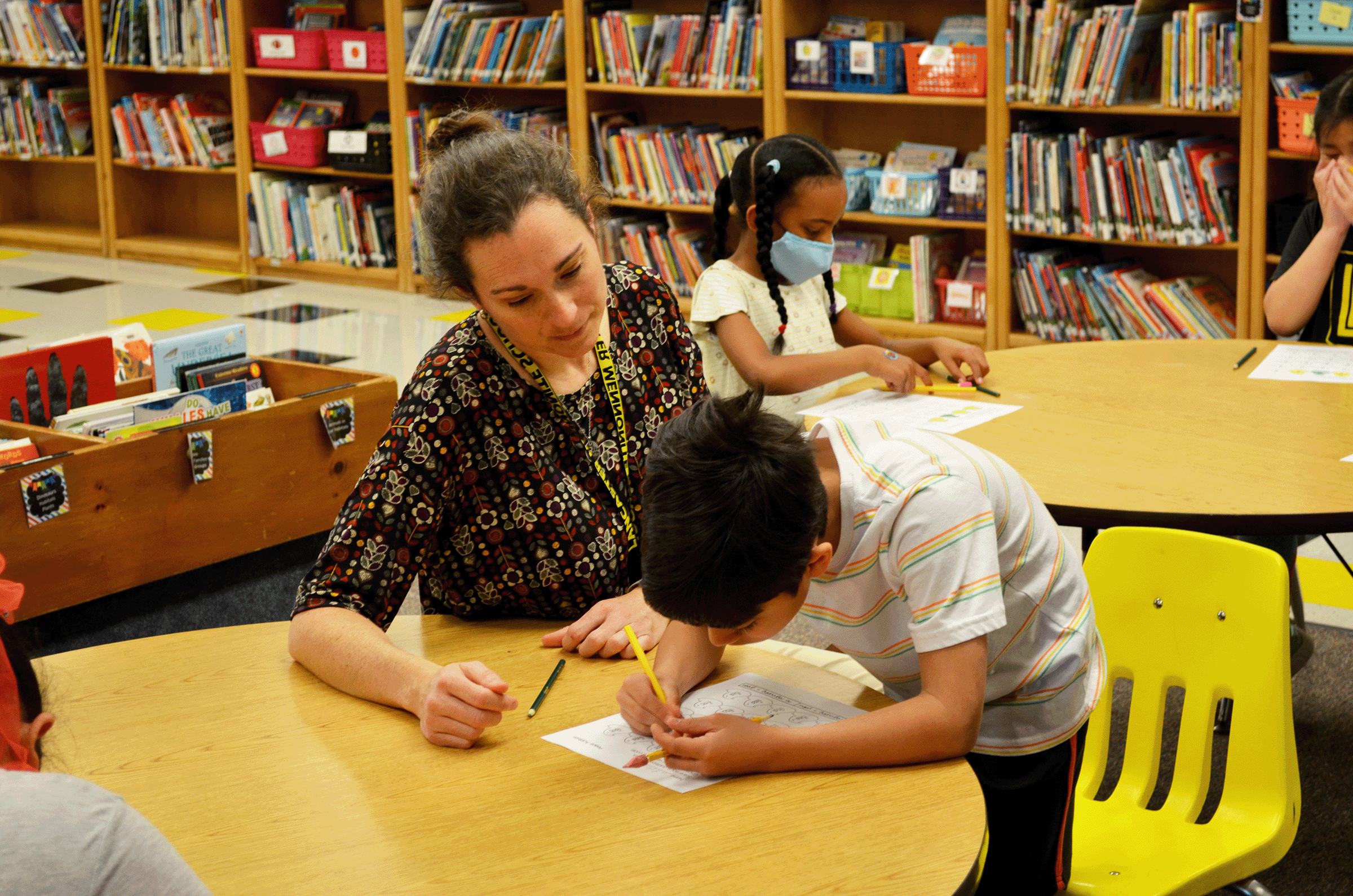 teacher helping boy with math work