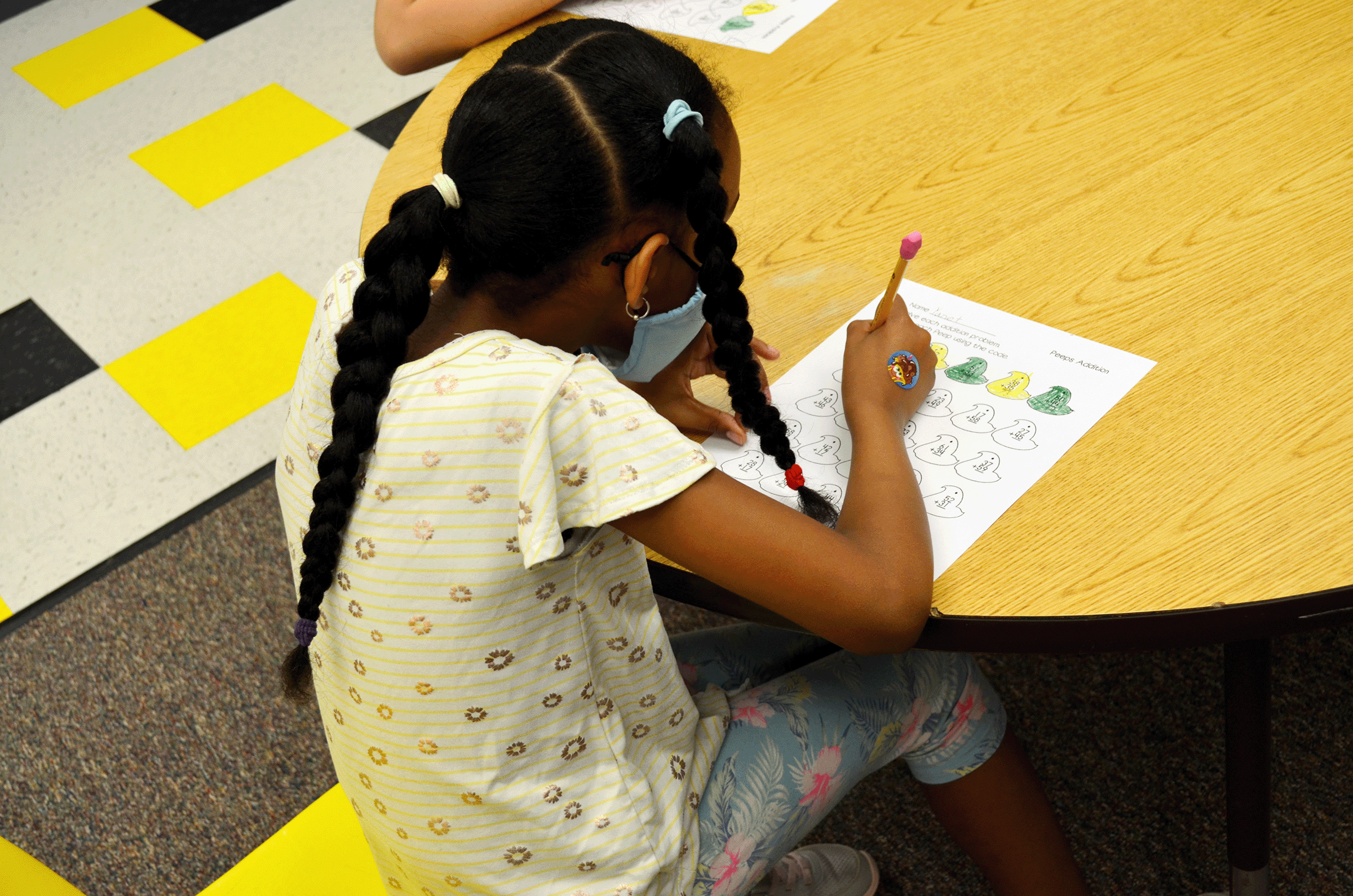 girl completing math work