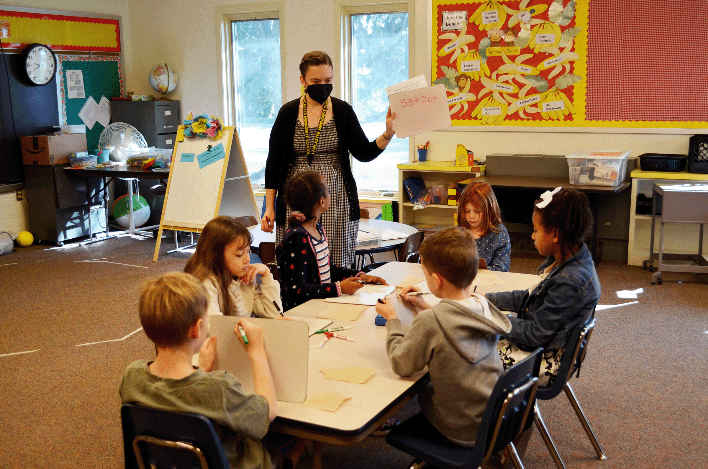 teaching math to table of young students