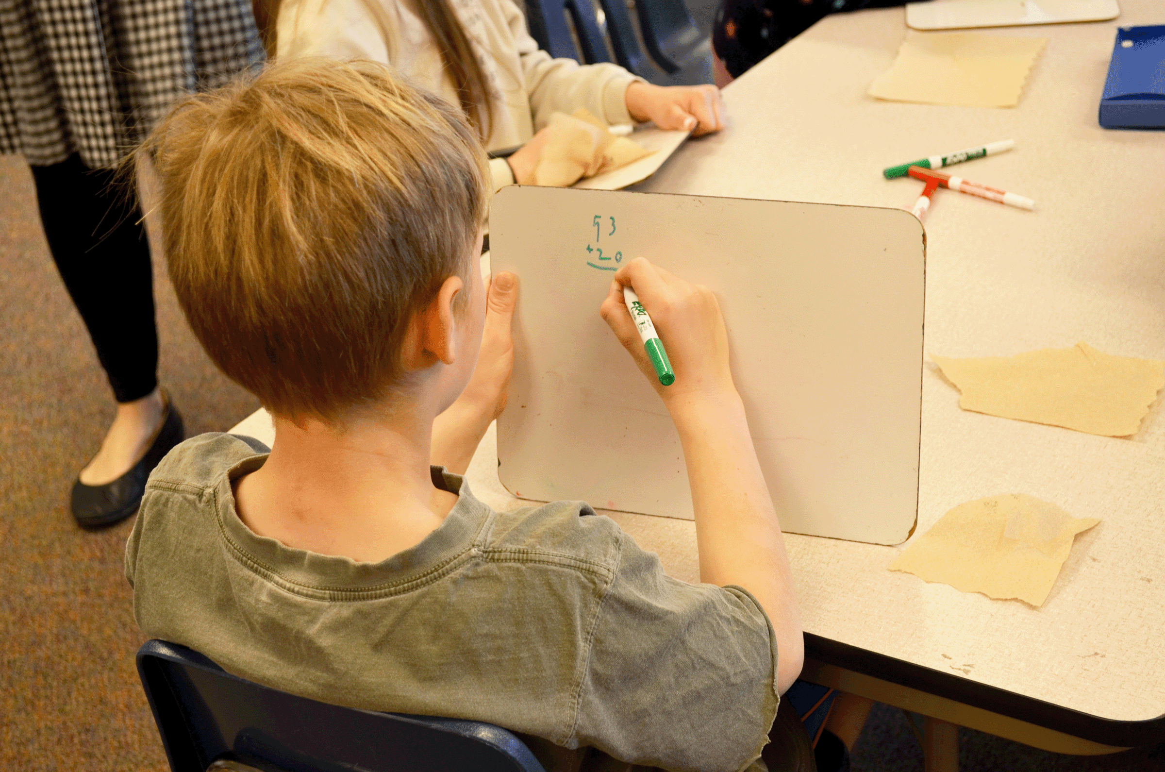 boy drawing on white board