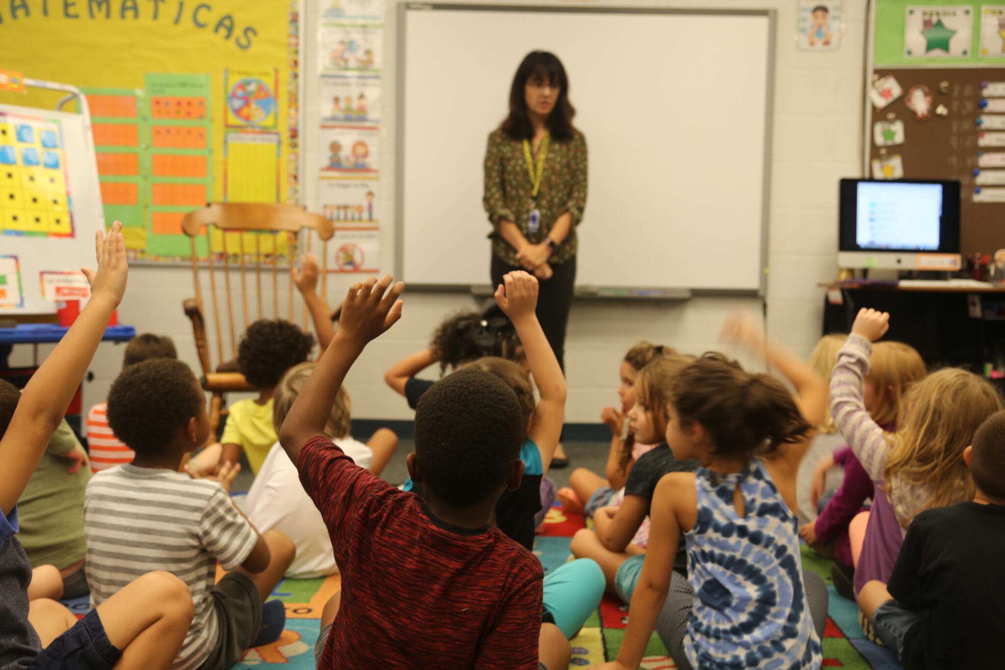 1st graders raising their hands