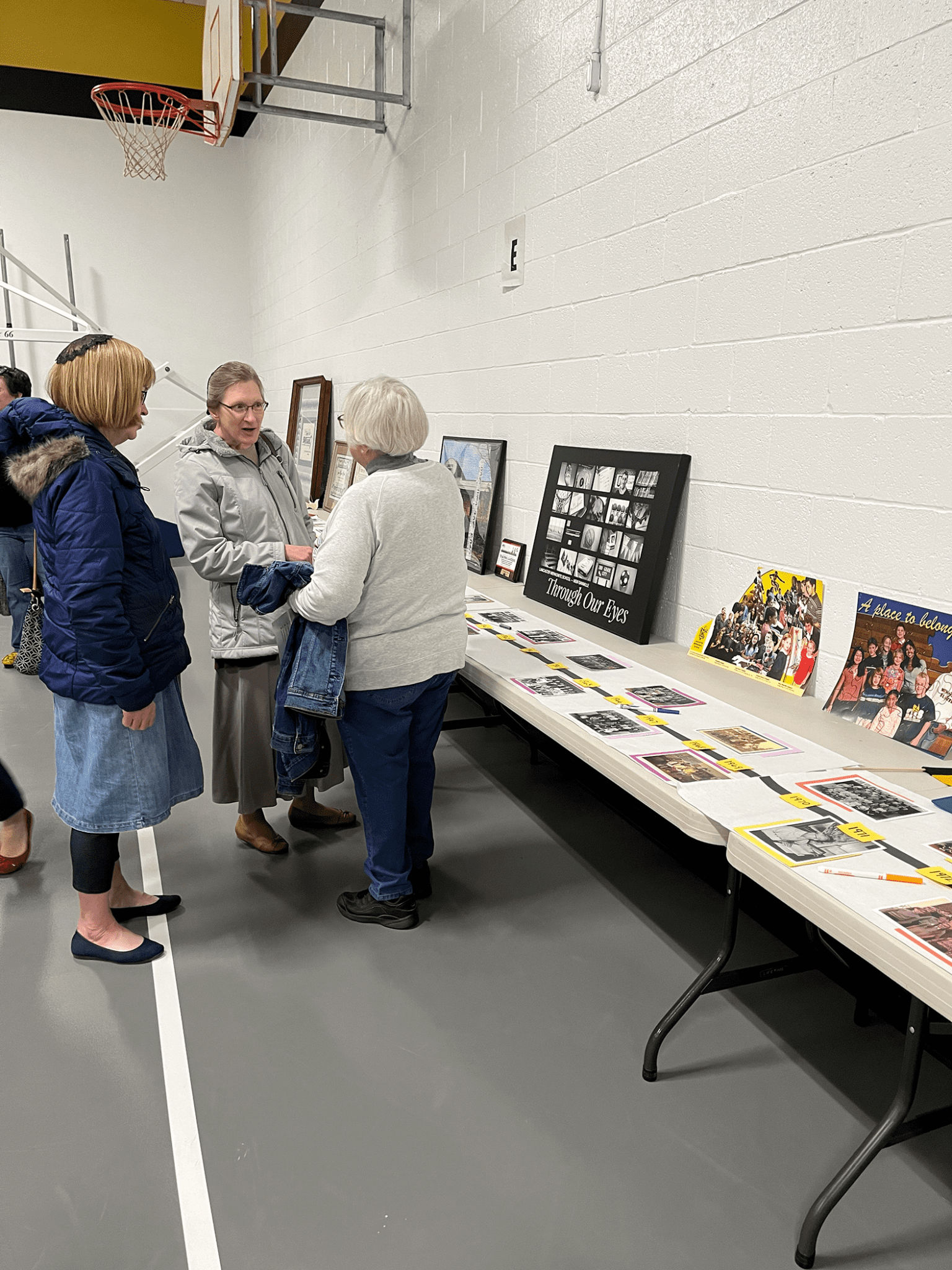 three mennonite women at fundraiser