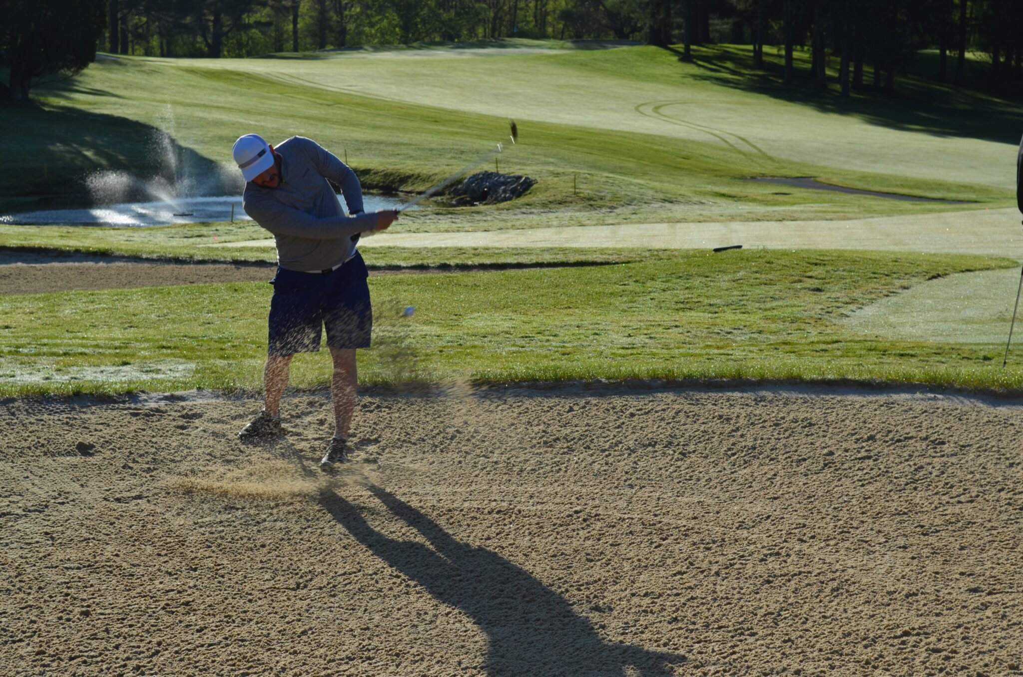 man putting from sand trap