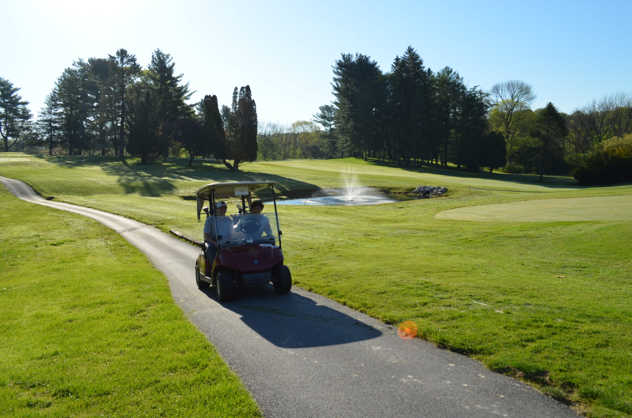 two people in a golf cart