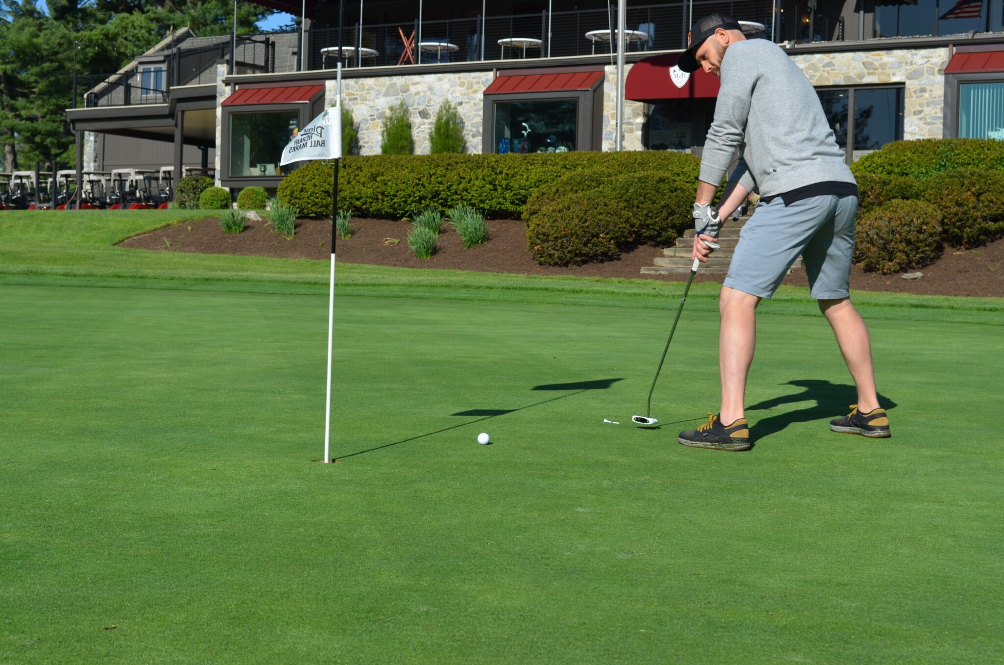 man putting a golf ball