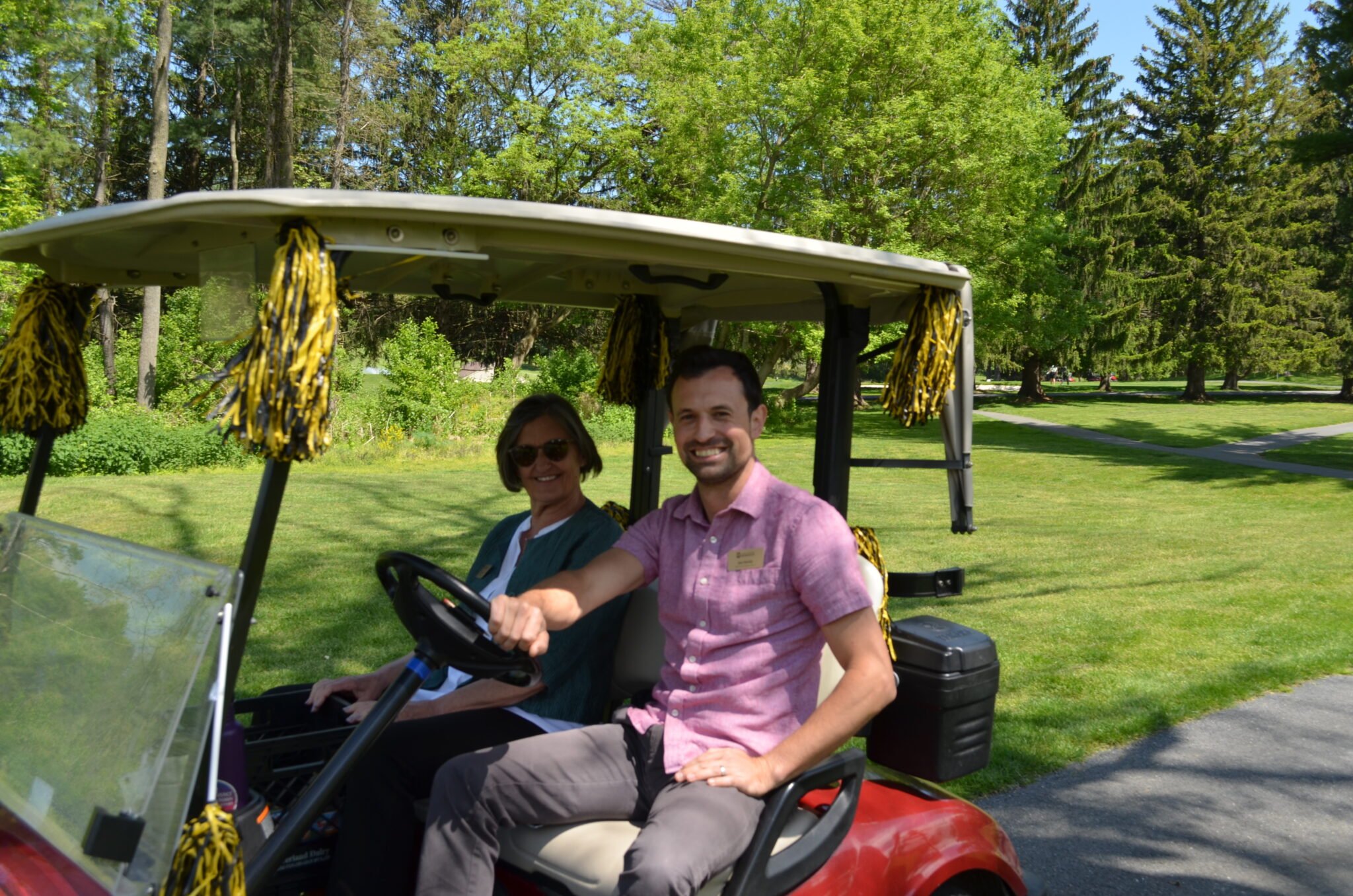 man and women in golf cart