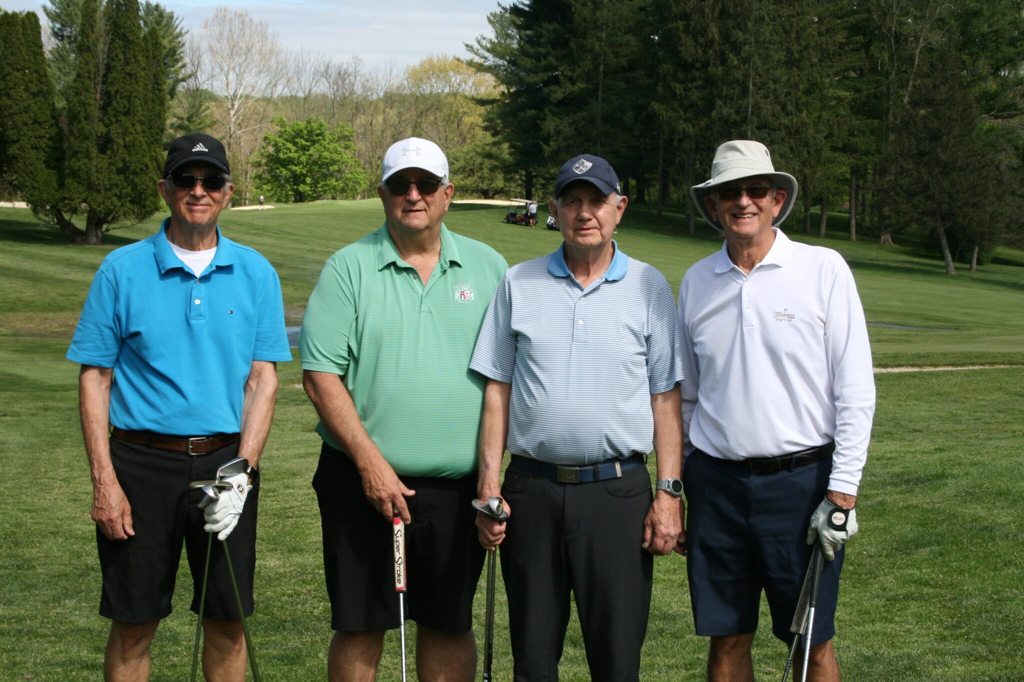 four men golfing