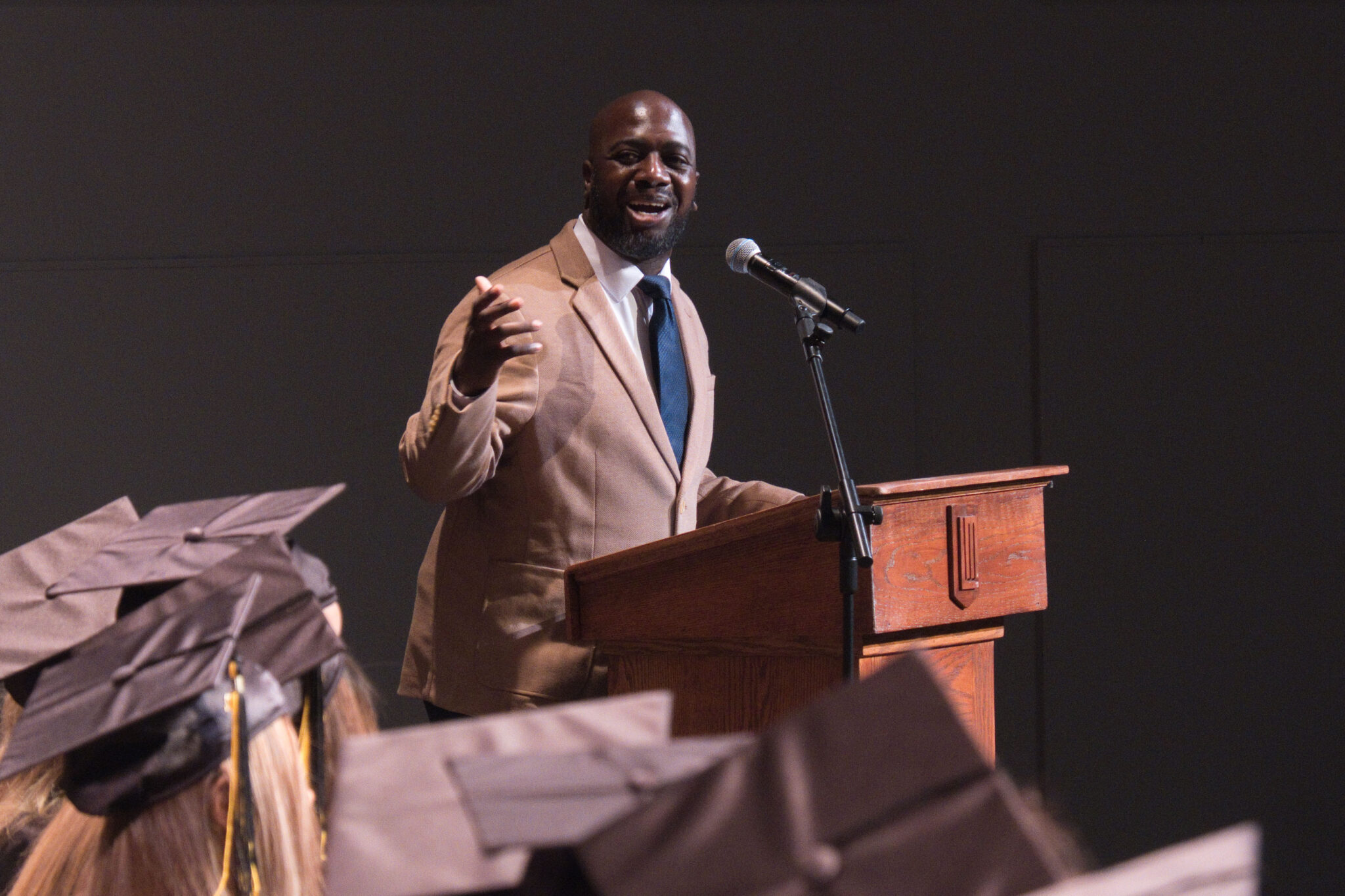 man speaking at podium