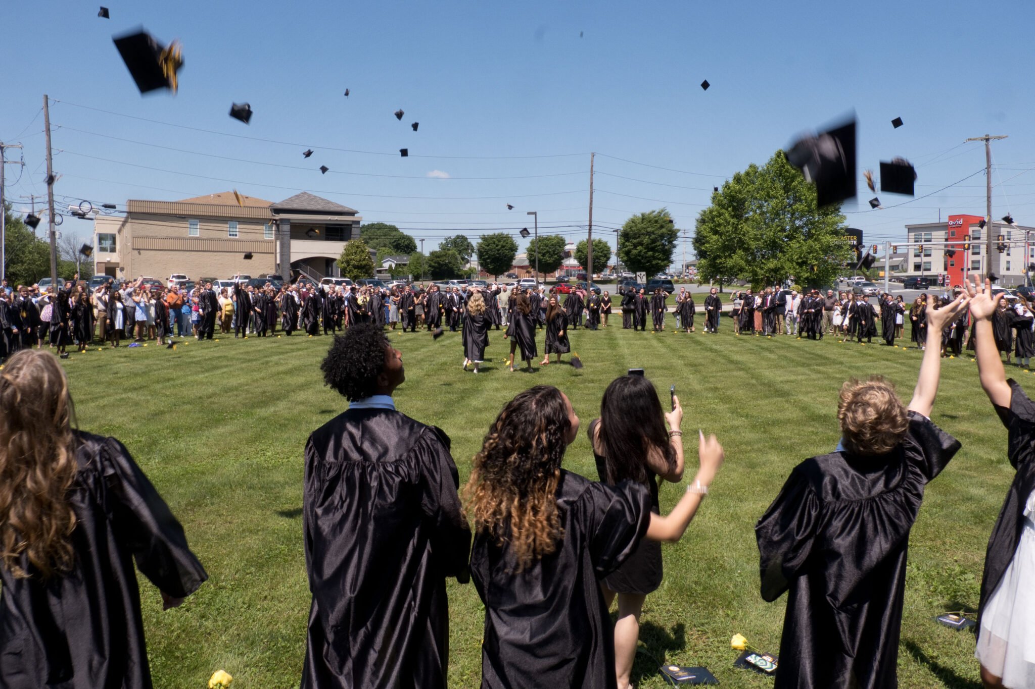 grads throwing caps