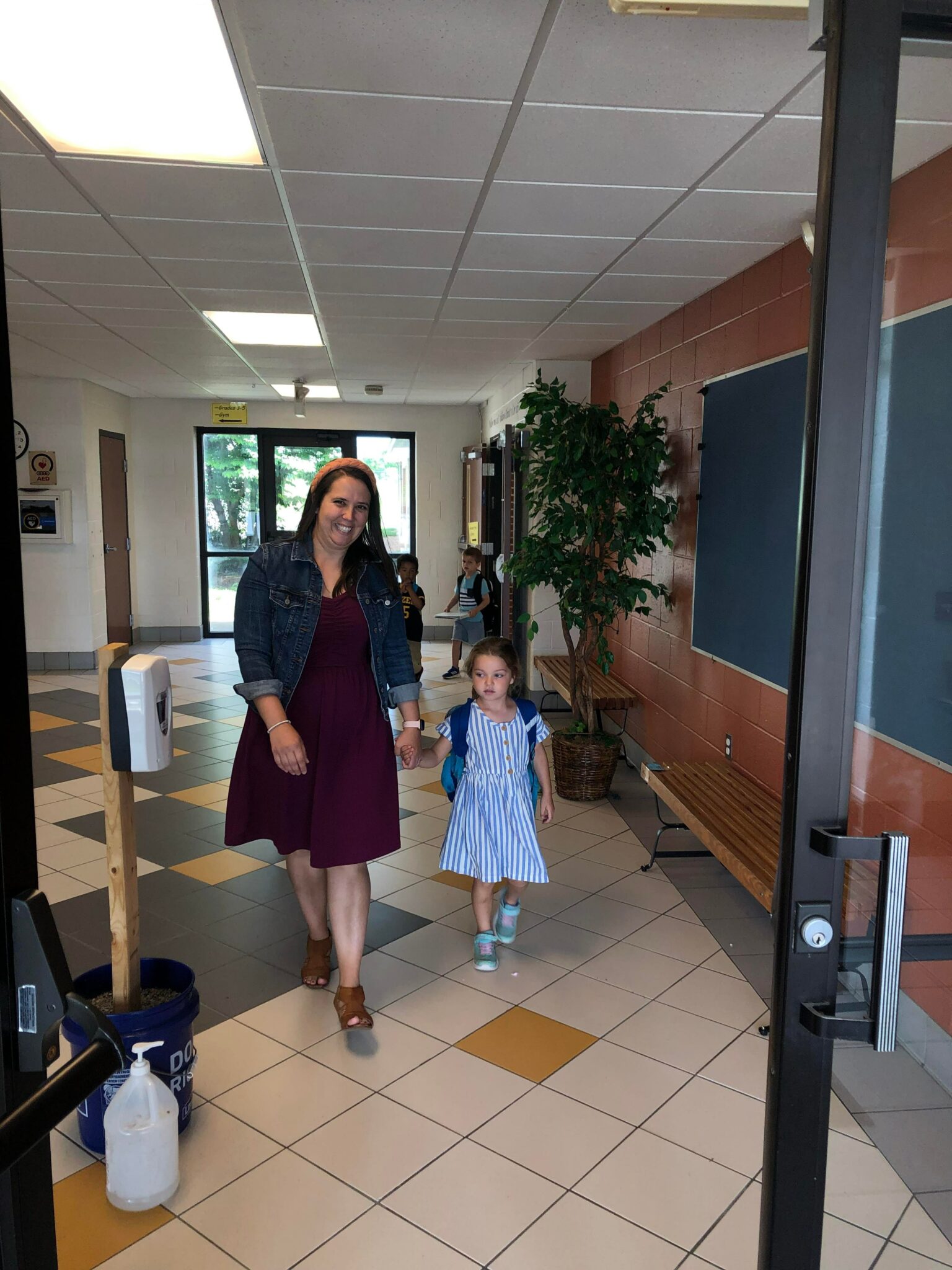 mom walking child into school