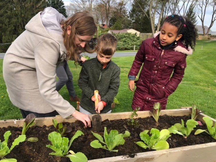 Students with teacher in the learning garden