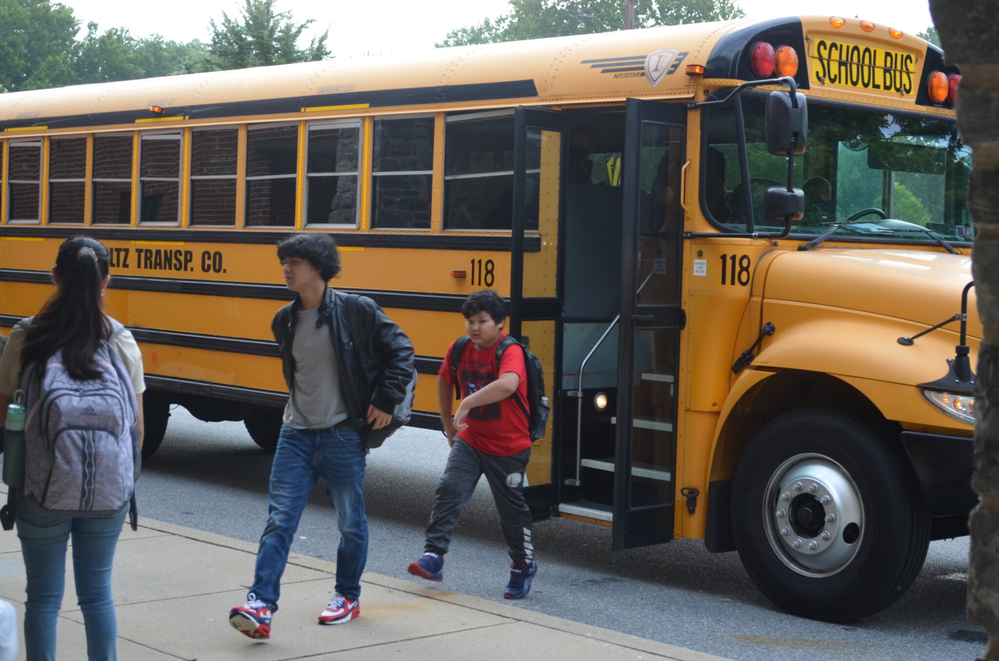 students getting off of the bus