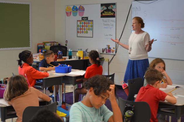 Teacher giving instructions to students