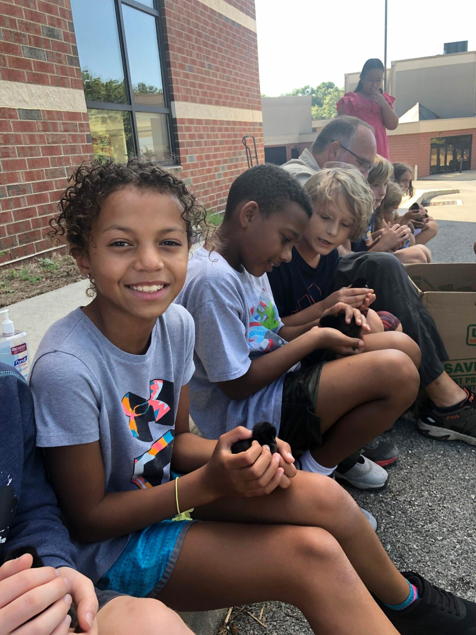 students holding chicks