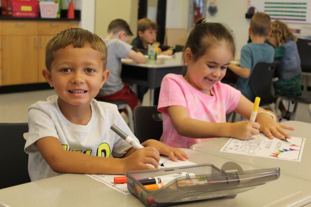 students coloring on the first day of school.