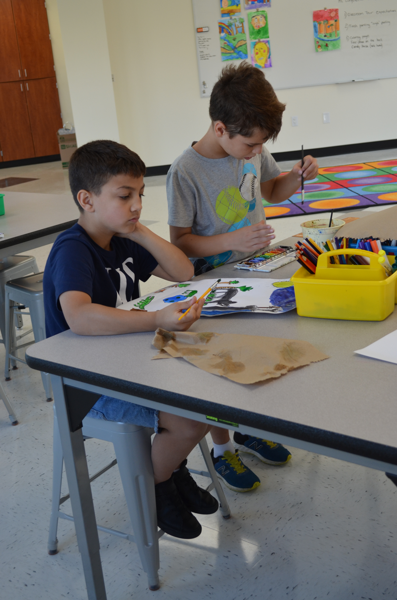 Two students painting in Maker Space