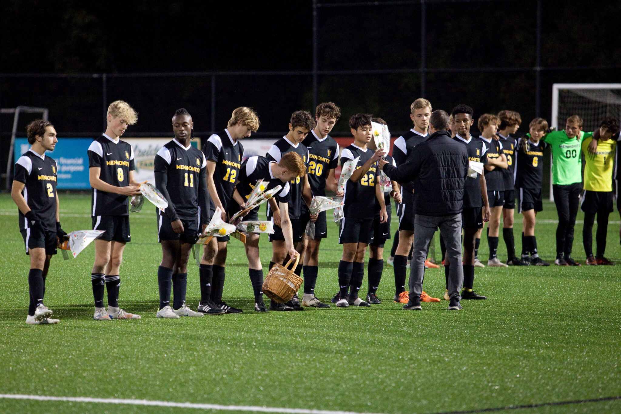 Soccer players receiving roses