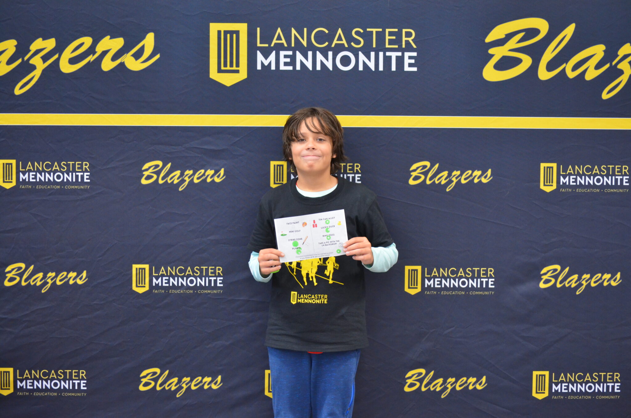 Student in front of photo wall