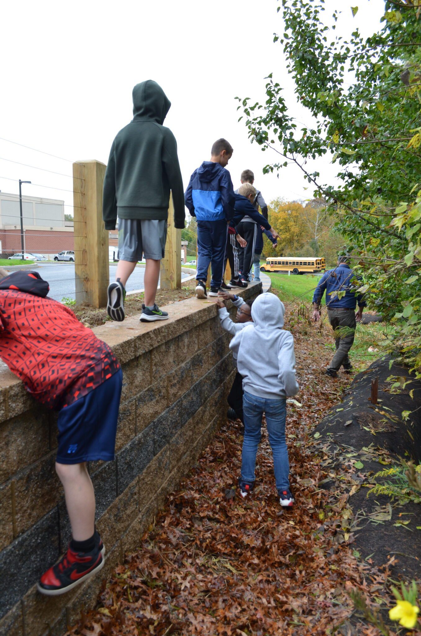 Students on nature walk with Mr. Sauder