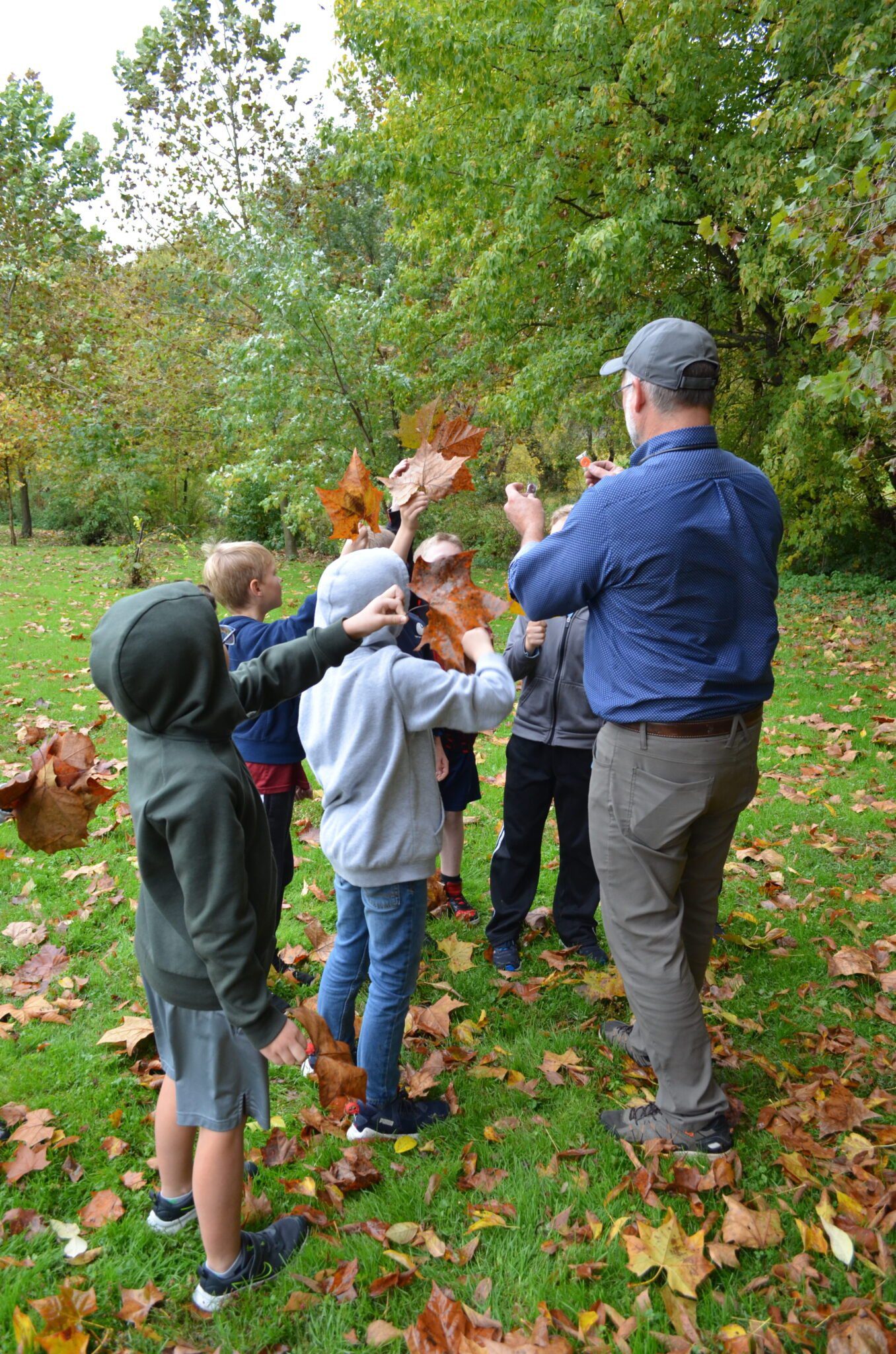 students outside looking for leaves