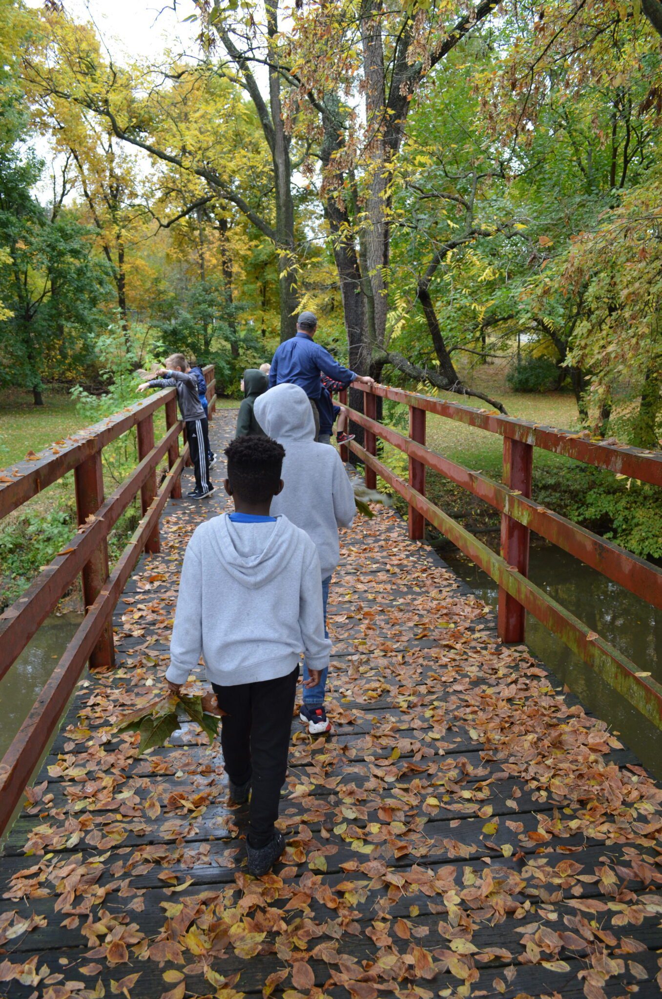 male students crossing bridge