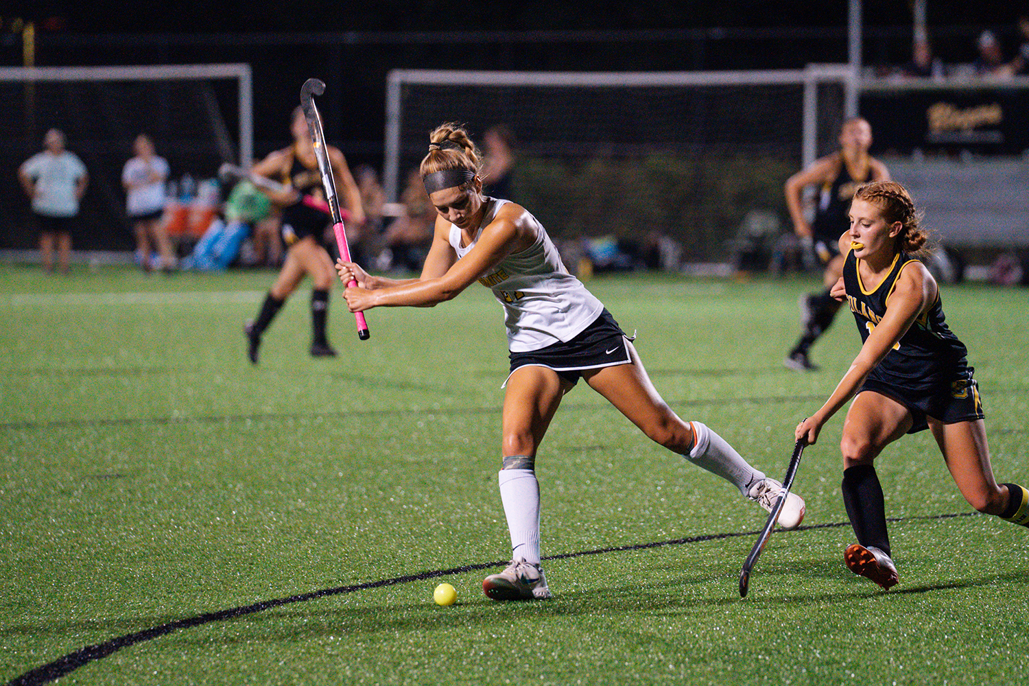 girls playing field hockey