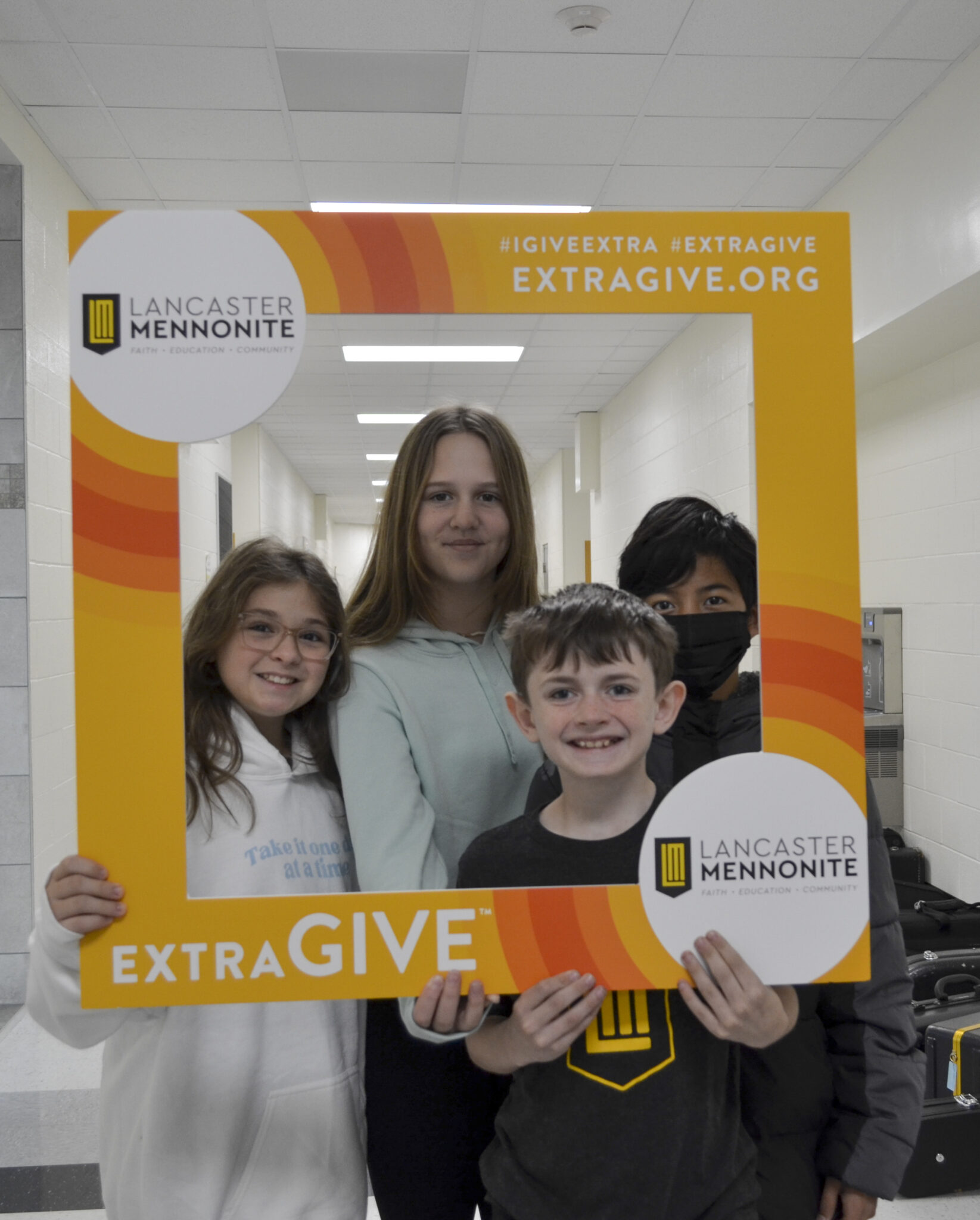 LM students in hallway with Extragive sign.