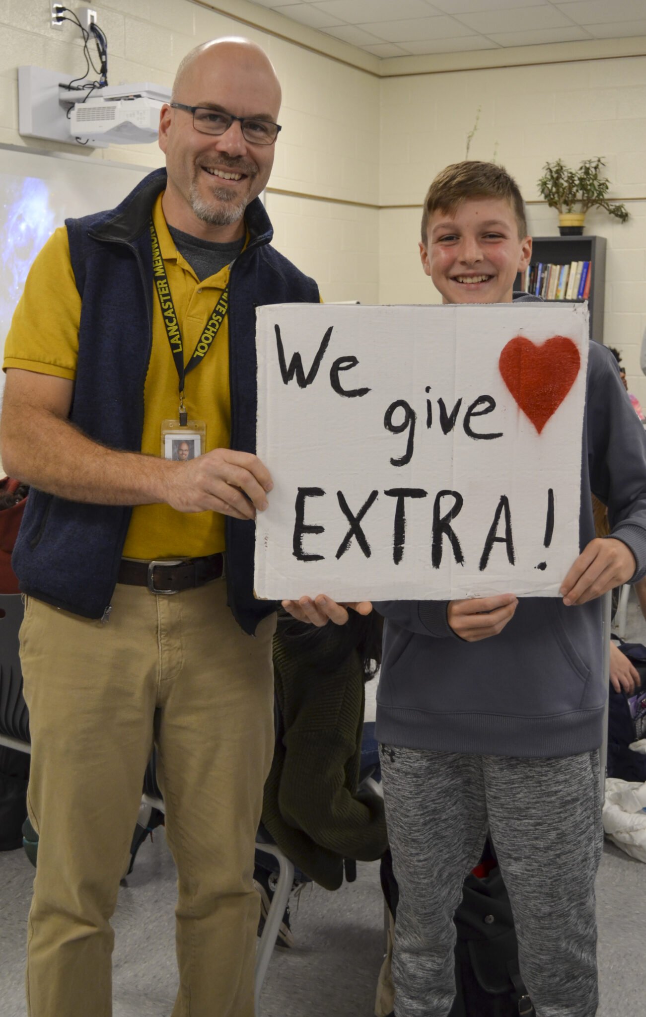 LM student and teacher holding up 