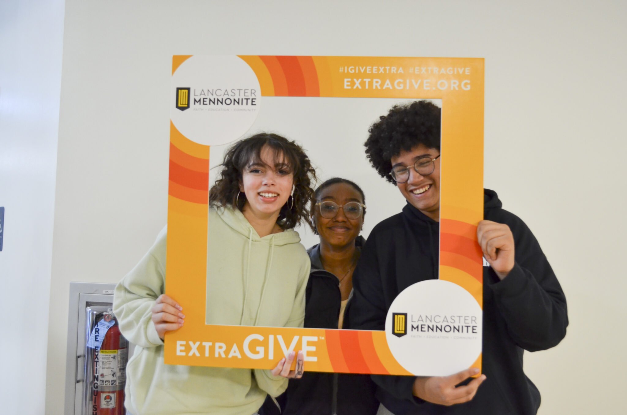 Students in the hallway with ExtraGive sign