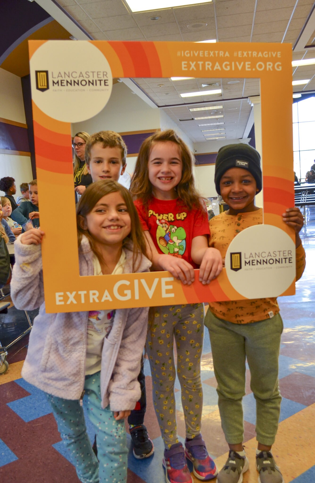 Elementary students at lunch with ExtraGive sign