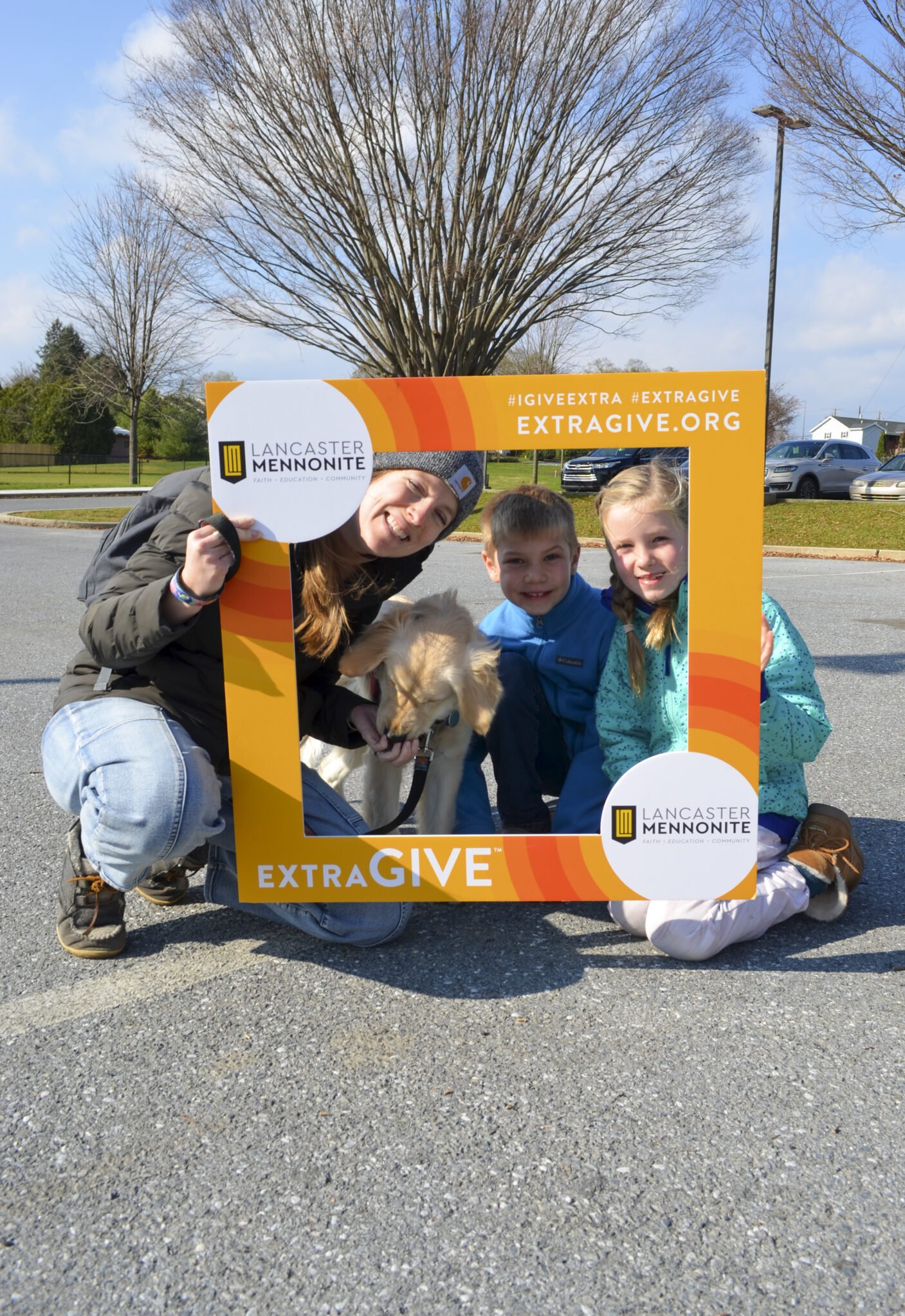 LM family holding the Extragive sign